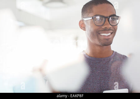 Portrait of young smiling businessman wearing glasses in office Stock Photo