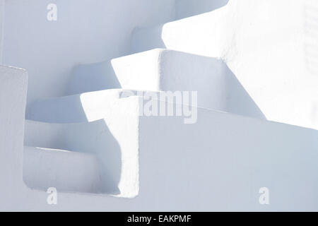 Minimal white stone staircase between two white walls, Oia, Santorini, Greece. Stock Photo