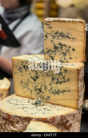 Stack of different sized portions of blue cheese on display Stock Photo