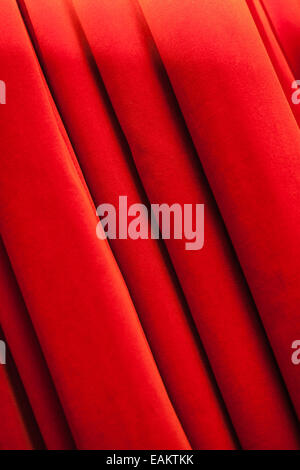 a closed red stage curtain in a small theater Stock Photo