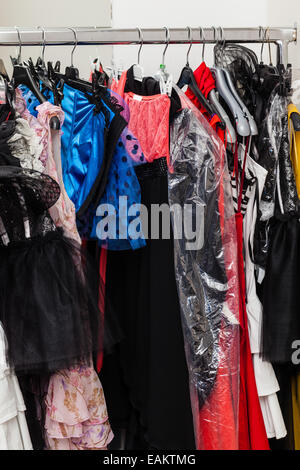 different costumes and wigs in the dressing room of a small theater Stock Photo