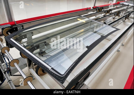 Industry detail with a rear car glass on the production line in a glass factory Stock Photo