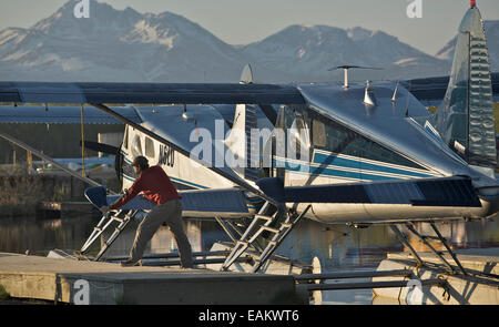 Pilot Prepares His Plane For Flight At Lake Hood In Anchorage, Alaska Stock Photo