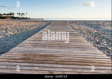 A wide angle low view of the boardwalk on the beach at Javea Costa Blanca Spain with nobody around in the early morning Stock Photo