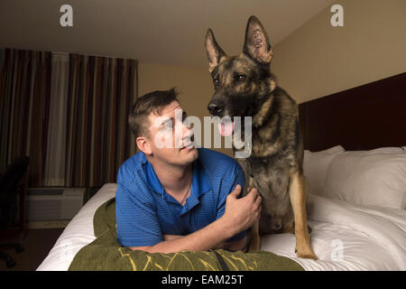 Nov. 15, 2014 - Fayetteville, NC - Army Spc. BRENT GROMMET was reunited with Matty, his U.S. Army trained German Shepherd, after being separated for more than a year. Both had been injured in the war. Grommet, now 23, came back from Afghanistan with traumatic brain injury, hearing loss and spinal-cord injury. Despite the veteran's right to adopt Matty, the bomb-detecting service dog mysteriously ended up another family with who took a liking to him and adopted him instead. Grommet's dad Don persevered for more than a year to locate Matty, despite threats of prison to his son from military off Stock Photo