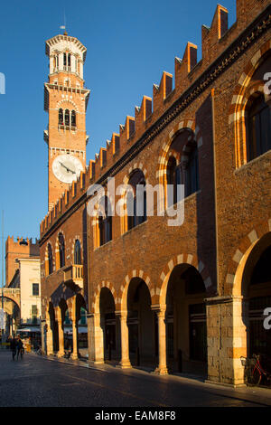 Setting sunlight on Lamberti Tower and the buildings of Verona, Veneto, Italy Stock Photo