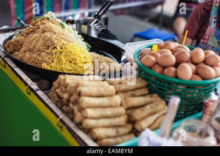 thai food stall in a street market in bangkok with noodles, spring rolls and eggs Stock Photo