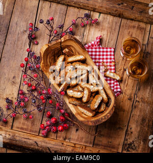 Cantucci in olive wood bowl on wooden background Stock Photo