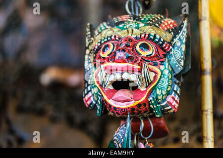 a traditional thai demon wooden mask on sale as a souvenir in the damnoen saduak floating market Stock Photo