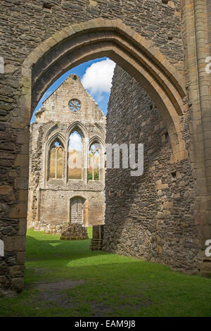 View, through ancient arched entranceway, of facade of 13th century Valle Crusis abbey ruins near Llantysilio in Wales Stock Photo