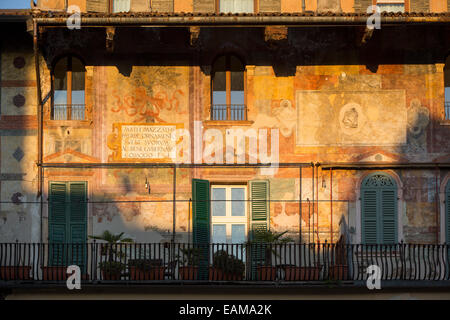 Setting sunlight on the historic buildings surrounding Piazza delle Erbe, Verona, Veneto, Italy Stock Photo