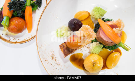 Pork two ways served in a fine dining restaurant. Stock Photo