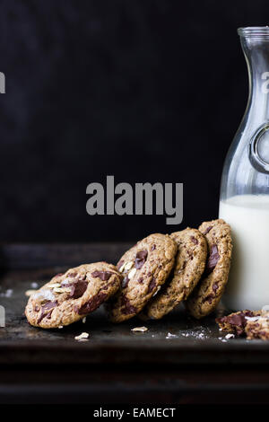 chocolate chunk cookies with oats, sea salt, and carafe of milk Stock Photo