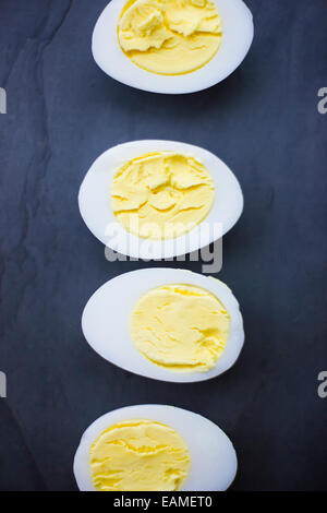 Hard Boiled Duck Egg Halves on Blue Slate Stock Photo