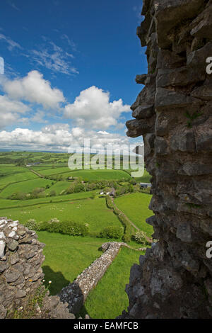 Spectacular view of vast emerald farmlands on rolling hills under blue sky from ruins of hilltop Carrig Cennen castle in Wales Stock Photo