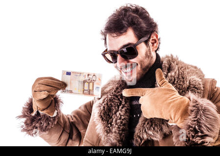 a young man wearing a sheepskin coat isolated over a white background holding banknotes Stock Photo