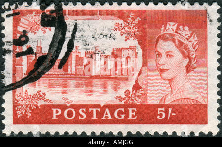 Postage stamp printed in England, shows a portrait of Queen Elizabeth II and Caernarfon Castle Stock Photo