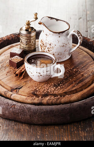 Hot chocolate sprinkled with cinnamon on dark wooden background Stock Photo