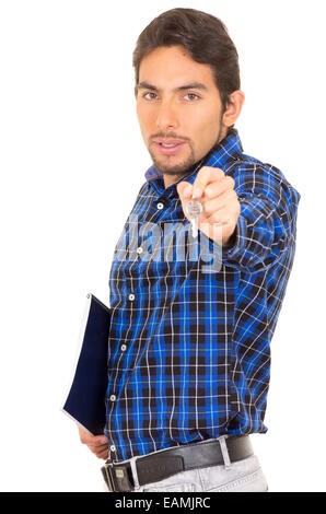 portrait of handsome hispanic male real estate agent holding a key Stock Photo