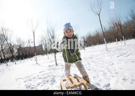 The little boy playing in the snow Stock Photo