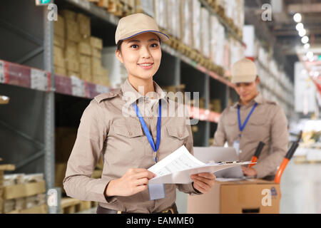 Oriental logistics personnel working in the warehouse Stock Photo
