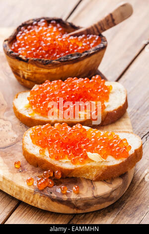 Sandwiches with Salmon red caviar on wooden background Stock Photo