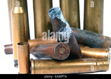 several shotgun shells in poor condition on white Stock Photo