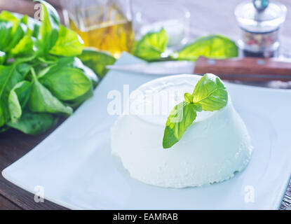 ricotta on the white plate and on a table Stock Photo