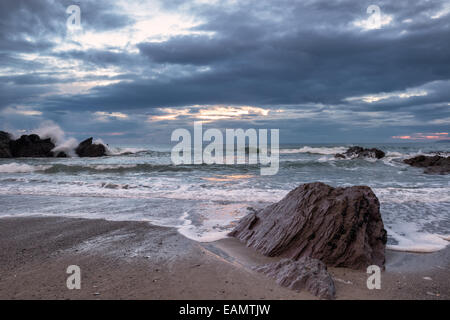 Waves crashing over rocks at Sharrow Beach on the Cornwall coast Stock Photo