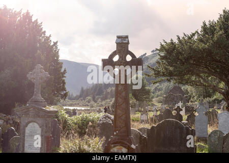 Old Celtic Cross in The Glendalough s Cemetery. Wicklow mountain, Ireland Stock Photo