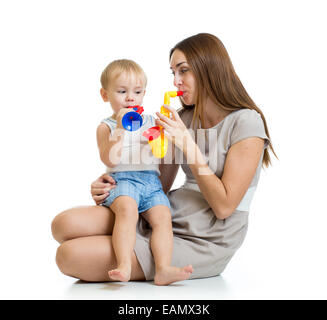 child and mother play musical toys isolated Stock Photo