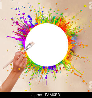 Concept of macro shots of colored paint splashes 'dancing' on sound waves and woman hand with paintbrush. Free space for text. Stock Photo