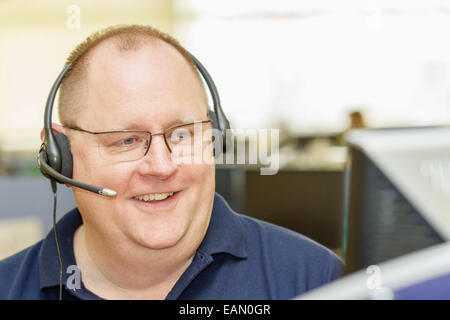 Call Centre - Middle-aged man wearing audio headset in telemarketing business Stock Photo