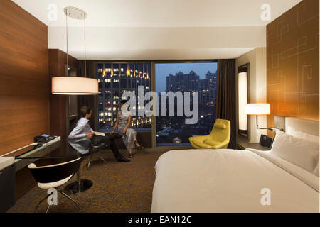 People in a room at The Langham hotel, Xintiandi, Shanghai, China Stock Photo