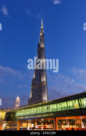 Modern architecture. Gangway to Dubai Mall and the tallest building  Burj Khalifa on the background in Dubai. Stock Photo
