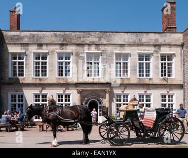 Cockington Court with Horse Drawn Hackney Carriage outside, Cockington Village, Torbay, Devon, England Stock Photo