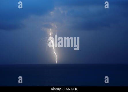 Lightning: A lightning bolt is captured during an electrical storm over the Atlantic Ocean. Stock Photo