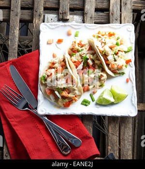 Lobster Tacos on a white plate with a red napkin Stock Photo