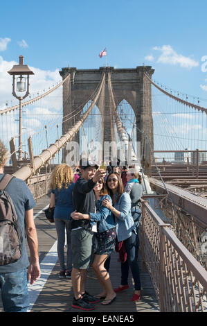 Young couple taking selfie on Brooklyn Bridge Manhattan, New York, USA Stock Photo