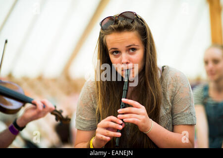 A young teenage girl playing traditional folk music on the tin recorder whistle  at the National Eisteddfod of Wales, 2014 Stock Photo