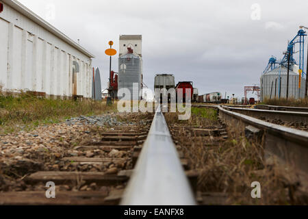 railway line approaching grain loading railway yard Saskatchewan Canada Stock Photo