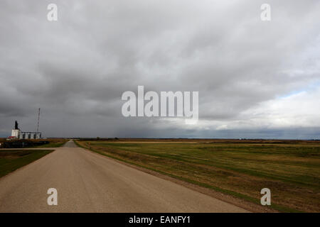 storm snow clouds forming over country road on the prairies assiniboia Saskatchewan Canada Stock Photo