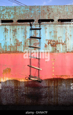 Depth markers on rusty hull of beached ship wreck Stock Photo