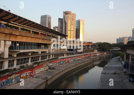 Metro train at Pasar Seni train station next to canal in Kuala Lumpur, Malaysia Stock Photo