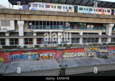 Metro train at Pasar Seni train station next to canal in Kuala Lumpur, Malaysia Stock Photo