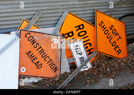 orange highway construction information signs lying in a yard Saskatchewan Canada Stock Photo