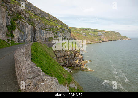 Narrow road, Marine Drive, winding around perimeter of hill, the Great Orme, at Llandudno with Irish Sea at base of high cliffs Stock Photo