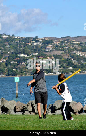 father and son practice baseball in public park in Marin County California Stock Photo