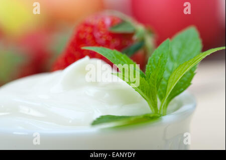 organic Greek yogurt and strawberry over white rustic wood table Stock Photo