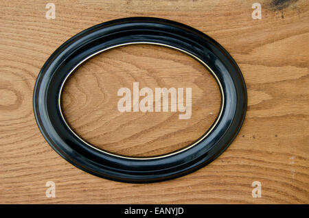 oval form picture photographs  frame on oak wood plank background Stock Photo